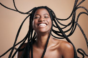 Laughing, joy and black woman with braids, hairstyle and...