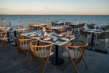 A romantic seaside restaurant with perfectly arranged...