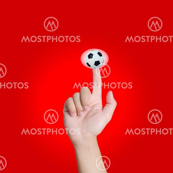 Hand pointing soccer in red background