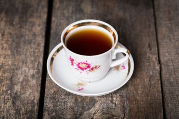 Closeup of cup of tea on vintage wooden background