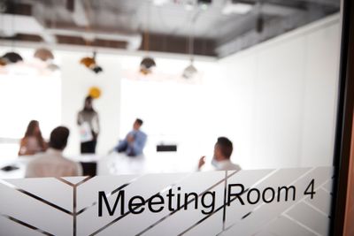 Boardroom Presentation Viewed Through Meeting Room Window