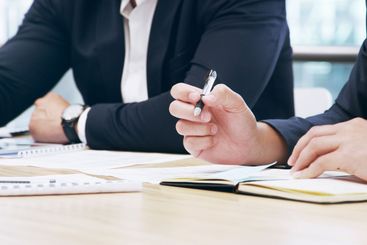 Teamwork, writing and notebook with hands of business...