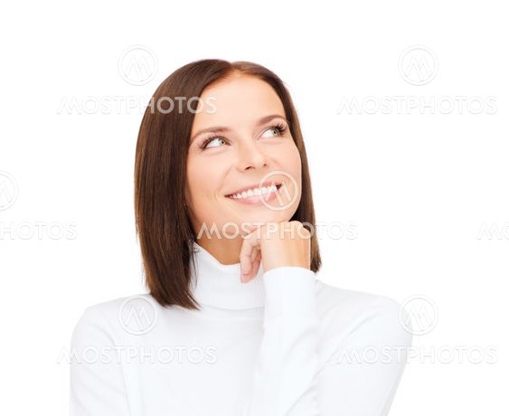 thinking and smiling woman in white sweater