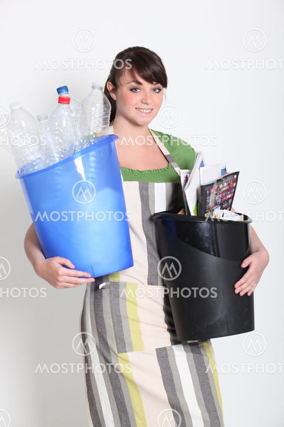 Brunette holding recyclable plastic and paper