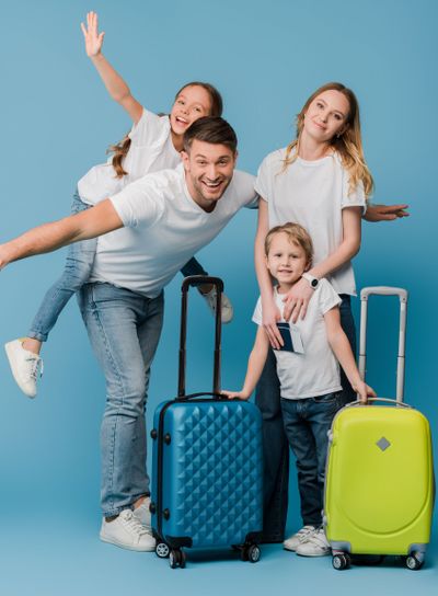 excited family of travelers with suitcases, passports...