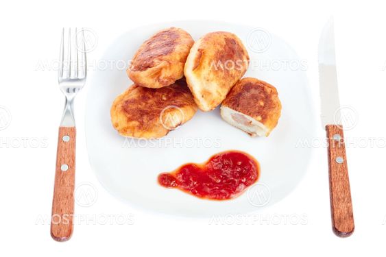 Meat pies on a plate for lunch. On a white background.