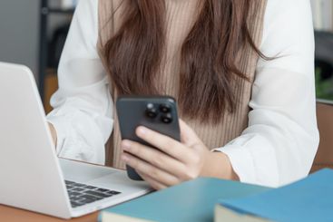 Asian woman using laptop to study student engaged in...