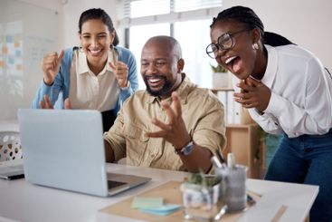 Business, team and celebration with laptop in office for...