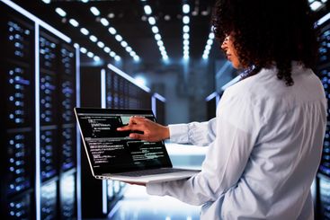 Cloud Computer Engineer Coding In Server Room In Data...