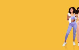 Two women enjoying fitness and hydration in bright...