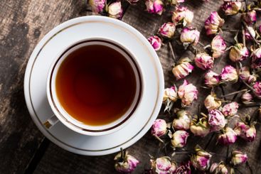 Vintage teapot and cup with blooming tea flowers on...