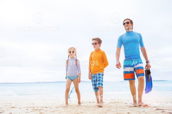 Father with kids at beach