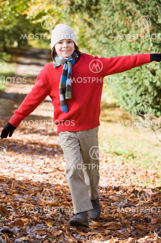 Young boy playing in woods