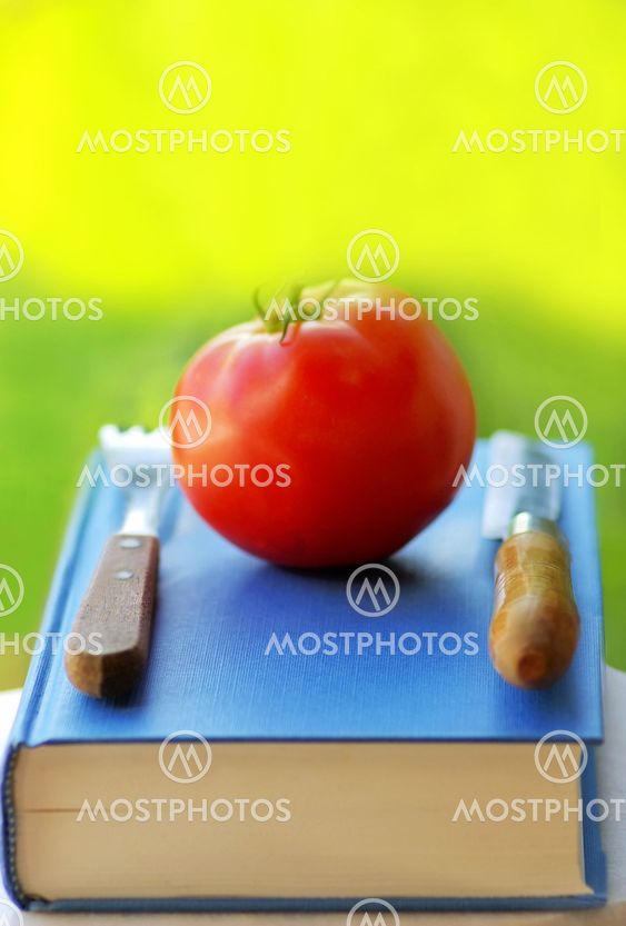 Red tomato on a book