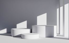Three white round product podiums in minimal style with...
