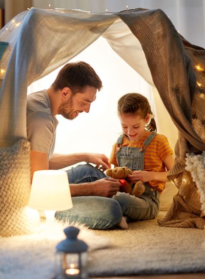 happy family playing with toy in kids tent at home