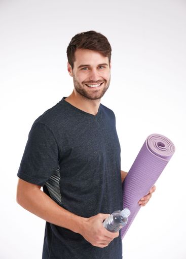 Man, mat and water bottle for exercise in studio...