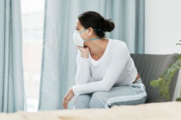 Woman, mask and window for covid, home quarantine and...