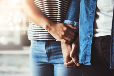 Holding hands, closeup and couple with love in home for...