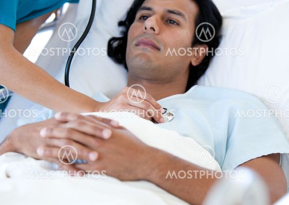 Hispanic patient examinated by a doctor on a medical bed
