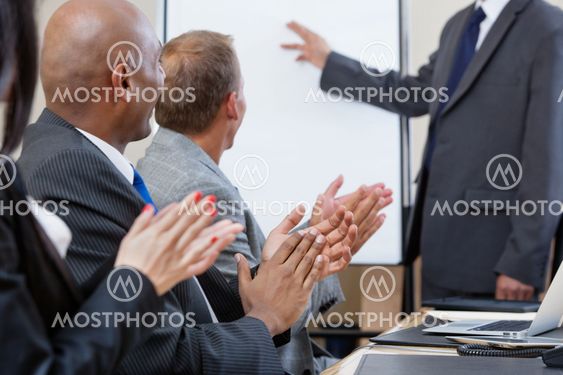 Business people applauding during presentation