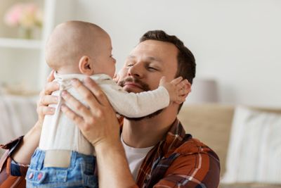 close up of father with little baby boy at home