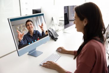 Latin business woman talking to female Indian online...