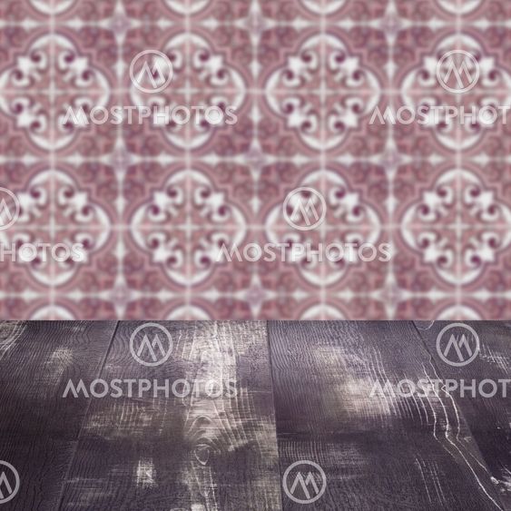 Wood table top and blur vintage ceramic tile pattern wall