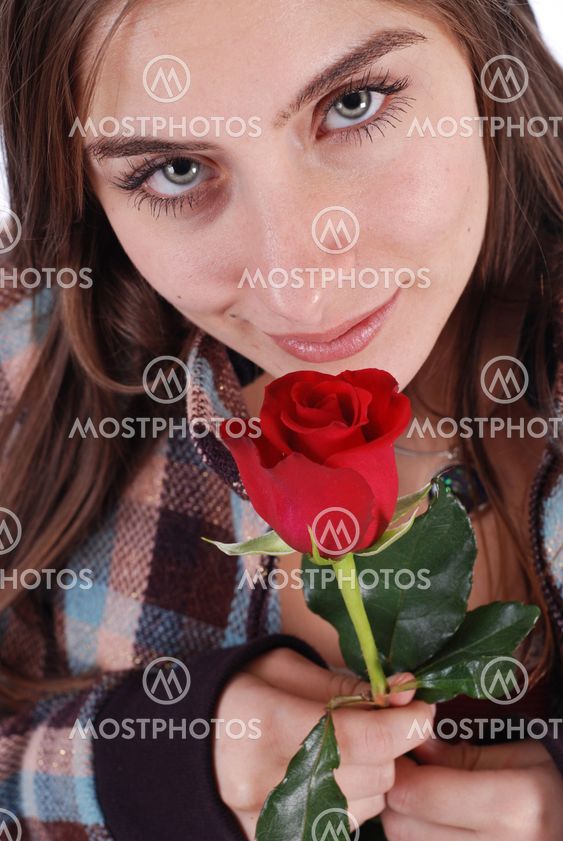 Beautiful girl smelling rose