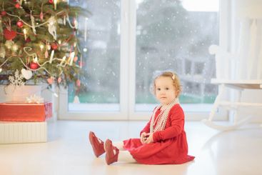 Child decorating Christmas tree. Kid on Xmas eve.