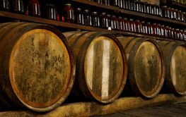 Old wine cellar with wooden oak barrels.