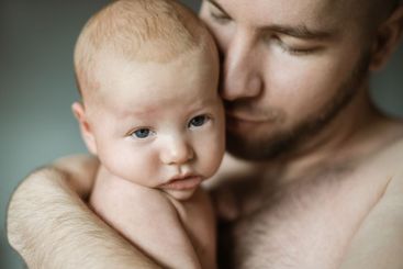 Family, baby and dad with a parent hugging his child in...