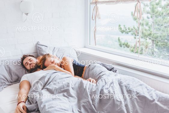 Young couple enjoying bed time in the morning