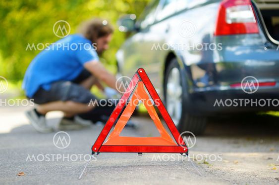 Red warning triangle sign on the road