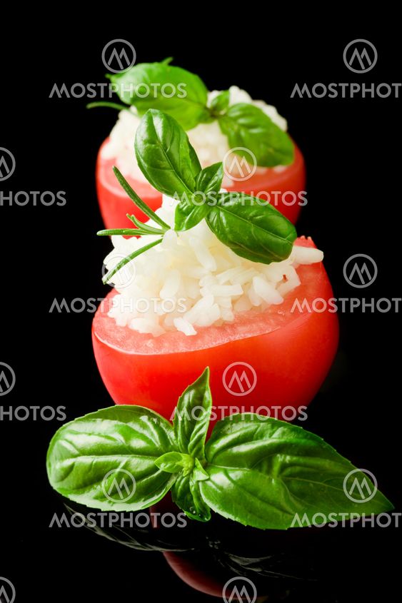 Stuffed tomatoes with rice isolated on black