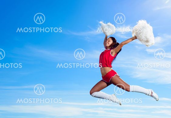 Young cheerleader in red costume jumping