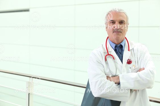senior physician in hospital hall with ex-rays