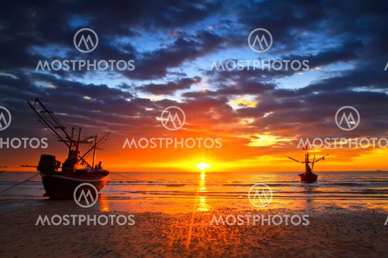 Sunset over the ocean and fishing boat
