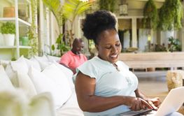 Happy senior african american couple in sunny living room, t