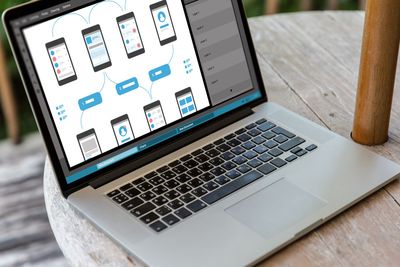 laptop with smartphone interface design on screen