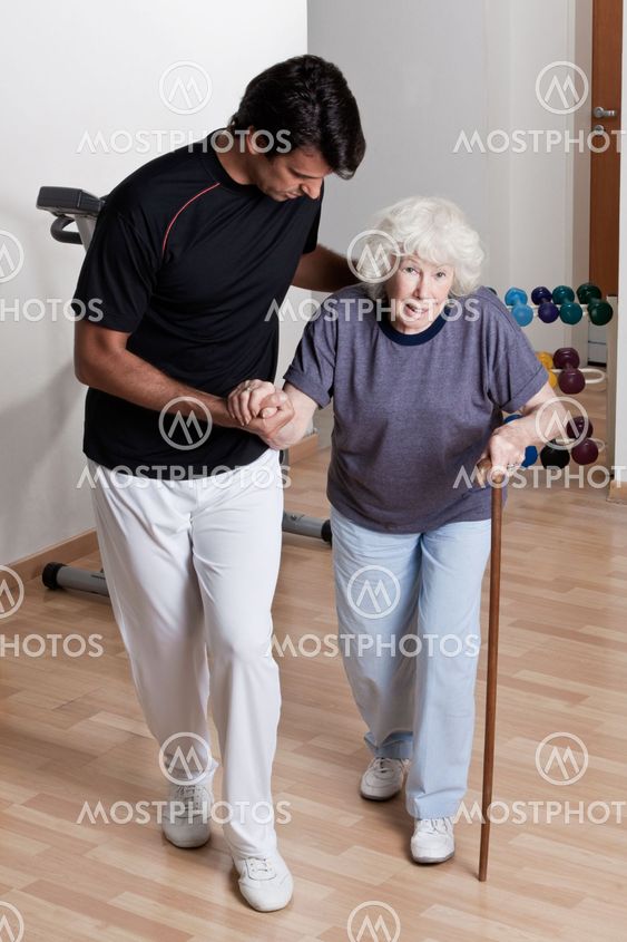 Therapist helping Patient To Walk