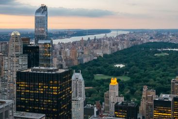 Central Park at dusk in Manhattan with skyscrapers in...