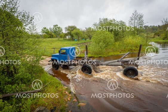 timber truck crosses the ford river