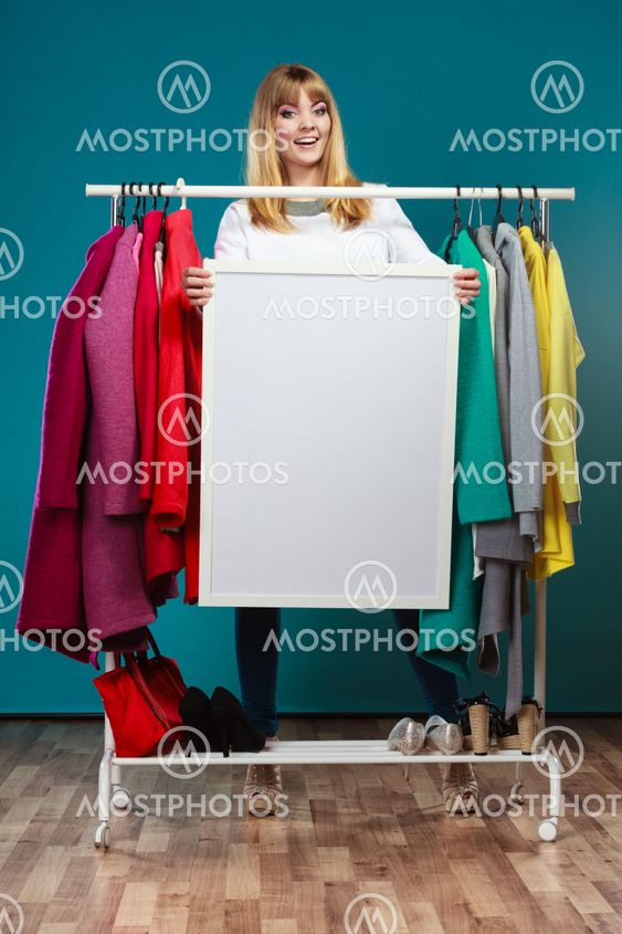 Woman in mall wardrobe with blank banner copyspace