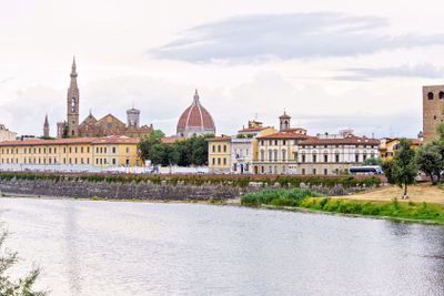 Daylight cloudy day view to Arno river with reflections
