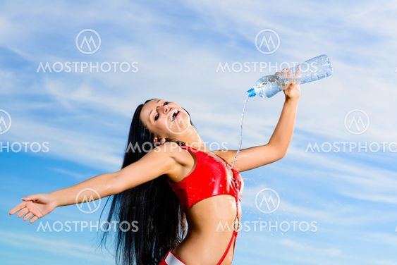 sport girl in red uniform with a bottle of water