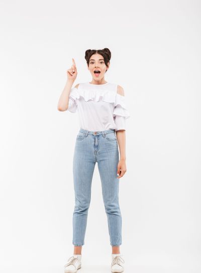 Full length photo of delighted girl 20s with double buns...