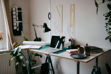 Laptop and office supplies on desk at home office
