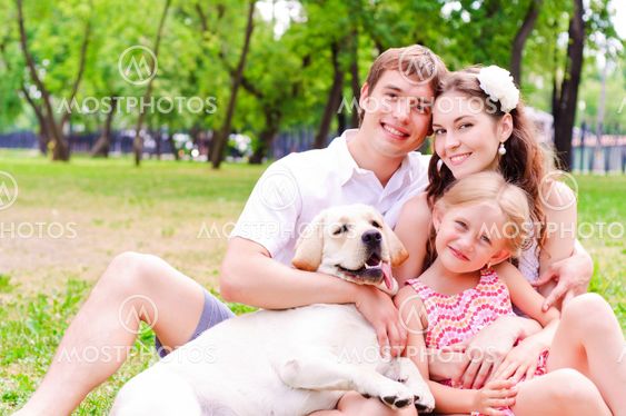 Happy young family with Labrador