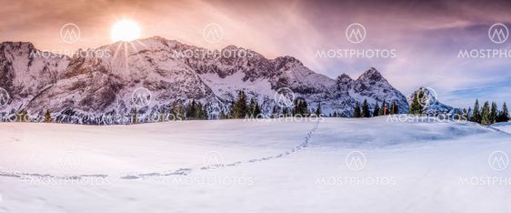 Mountain peaks with footsteps on snow